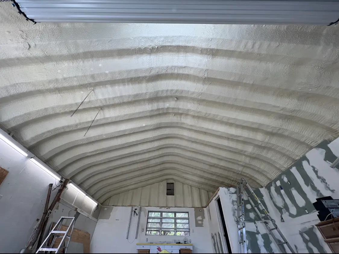 Spray polyurethane foam applied to the underside of a metal roof deck in De Pere